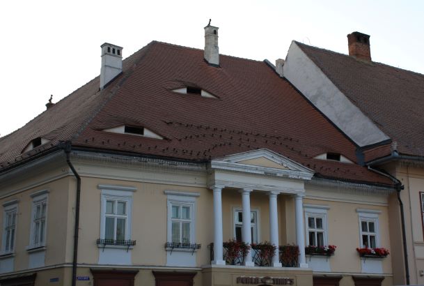 unique windows on the rooftops of houses look like eyes in Sibiu, Romania