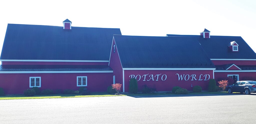 long red building with the words potato world on the side - this is the potato world museum in florenceville-bristol New Brunswick