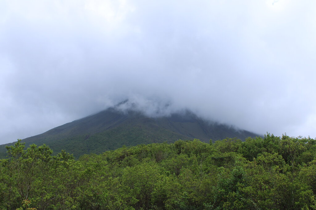 view of arenal volcano with clouds covering the top