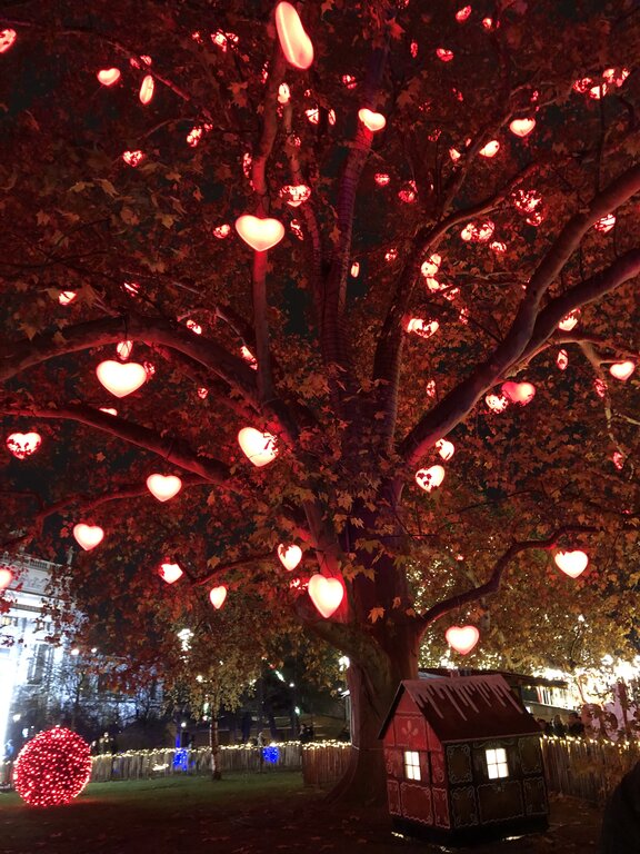 lighted red heart hang in a tree known as the tree of hearts at vienna christmas market