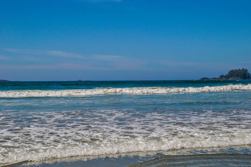 Gentle waves roll onto the sandy shore at Long Beach in Pacific Rim National Park, a popular destination near Tofino on Vancouver Island, Canada.